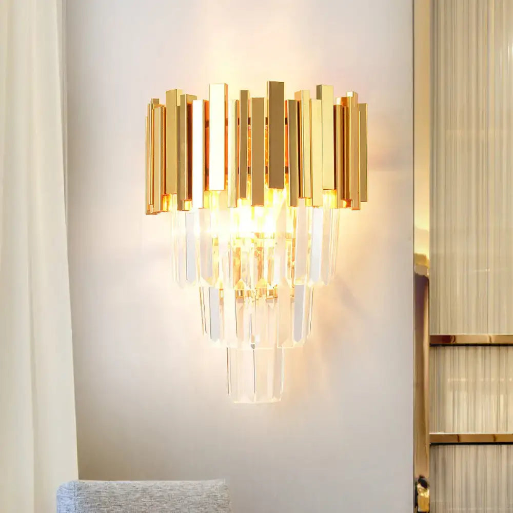 Modern gold crystal wall sconce with vertical brass bars and cascading clear crystal prisms for living room