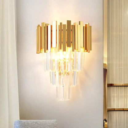 Modern gold crystal wall sconce with vertical brass bars and cascading clear crystal prisms for living room