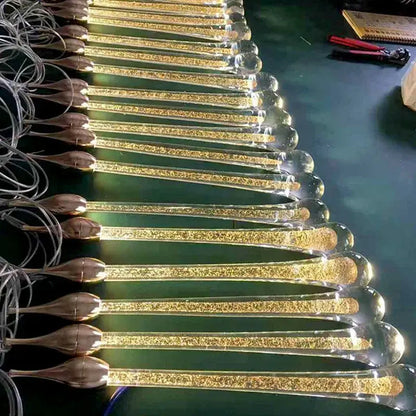Modern gold crystal water drop chandelier pendant light featuring golden glitter-filled glass rods with bronze caps
