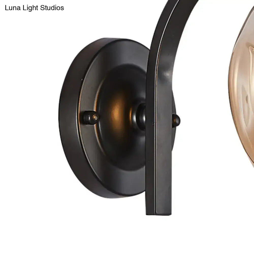 Black metal wall sconce with curved arm and circular backplate suitable for modern gold curved arm glass wall sconce bedroom light
