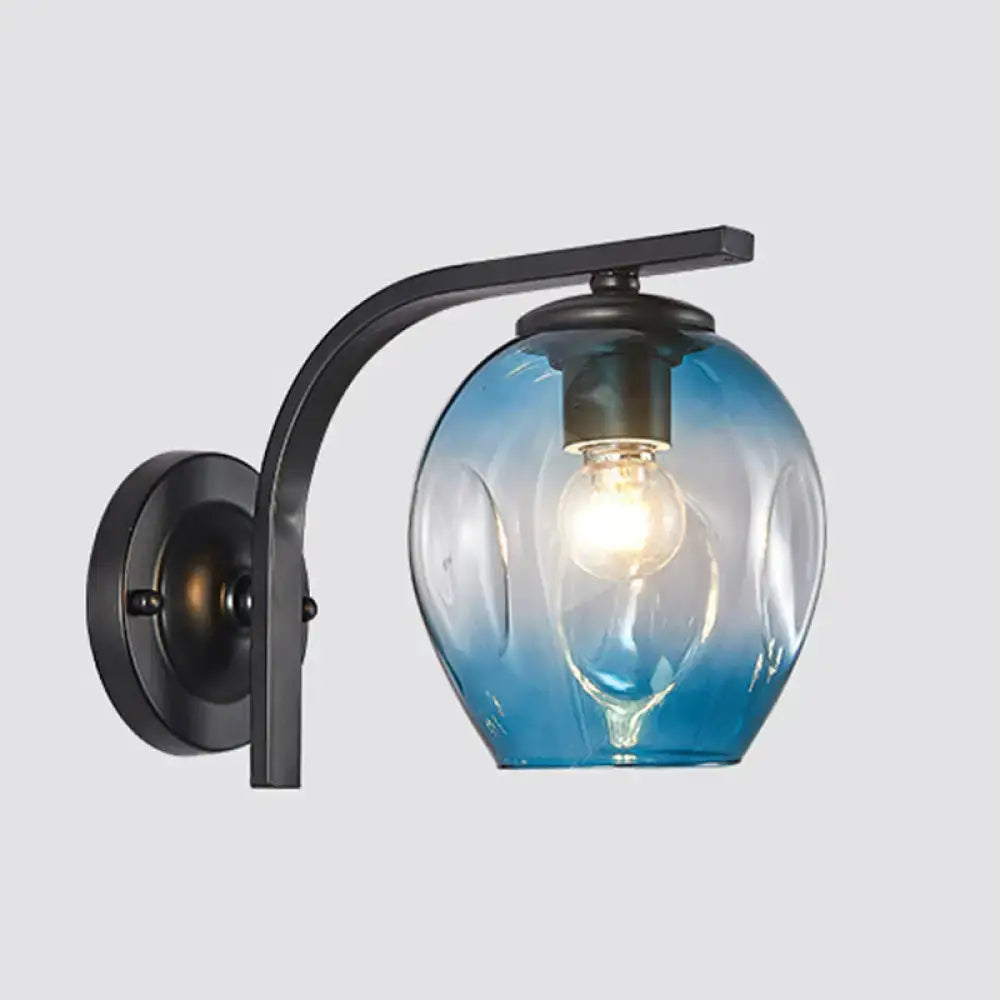 Modern gold curved arm glass wall sconce with blue gradient glass globe and black metal arm for bedroom lighting