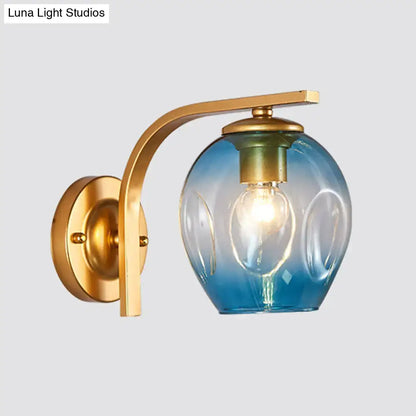 Modern gold curved arm glass wall sconce with brass finish and blue green gradient embossed glass globe for bedroom light