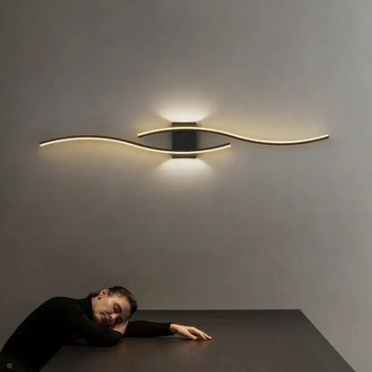 Modern gold curved led wall lamp with sleek design and warm ambient lighting for bedroom use