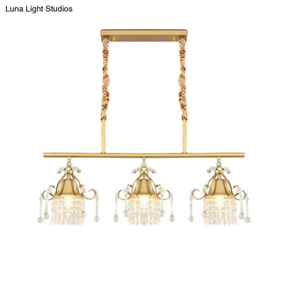 Gold-toned DecorBites™ island pendant light with three crystal teardrop heads and twisted rope gold cylinder cords