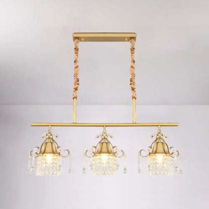 Gold-toned DecorBites™ crystal teardrop island pendant light with gold cylinder and three ornate crystal pendant heads
