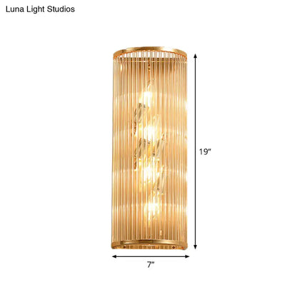 Modern gold cylinder wall mount lamp featuring vertical crystal rods and warm glowing light for hallway use