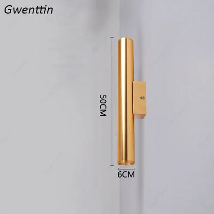 Modern gold cylindrical wall sconce light fixture with sleek metallic finish and rectangular mounting bracket for living room