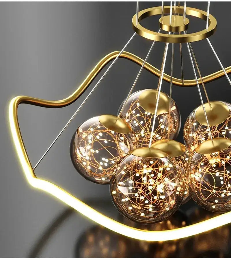 Modern gold decorbites bubble chandeliers with five spherical glass globes featuring intricate golden wire filaments and warm led lights