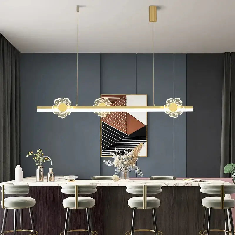Modern gold decorbites butterfly flower chandelier with three illuminated floral pendants above a dining table