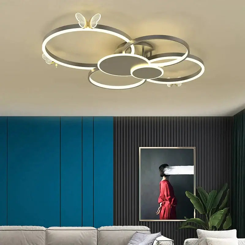Modern silver-toned decorbites butterfly light ceiling fixture with interconnected rings for living room lighting