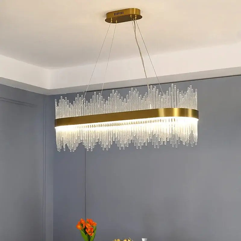 Modern gold decorbites crystal chandelier with oval metal frame and cascading clear glass rods for living room lighting