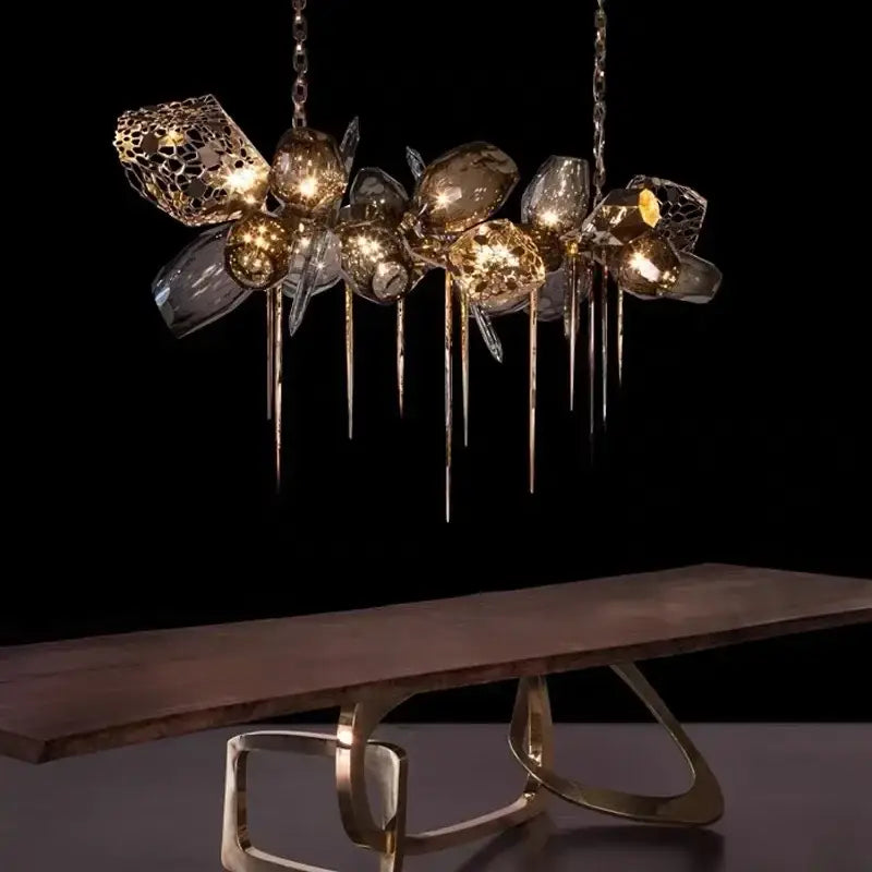 A modern gold decorbites crystal duplex chandelier with clear glass orbs and intricate metallic lattice for living room light
