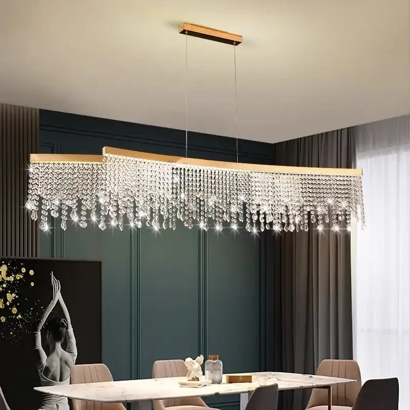 A modern gold decorbites crystal led chandelier with cascading clear crystal droplets for dining room ceiling