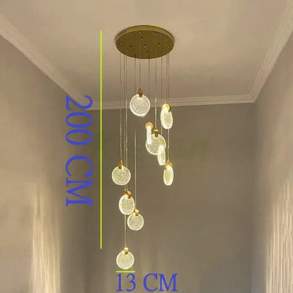 A modern gold decorbites crystal led chandelier features multiple spherical glass orbs suspended from a circular mount