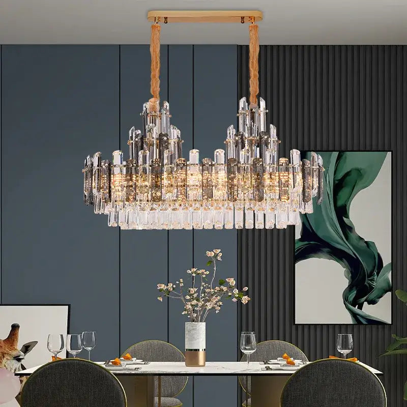 A modern decorbites crystal led chandelier with clear prisms, gold metal accents, and wooden cords for dining rooms