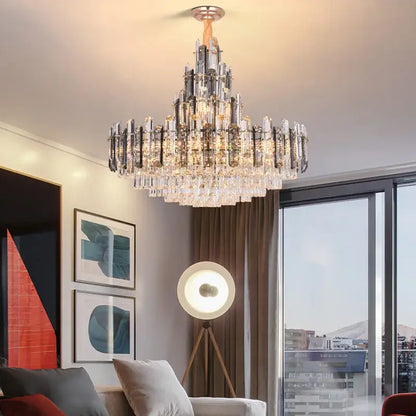 A modern decorbites crystal led chandelier with tiered gold and clear crystal prisms on polished chrome frame for dining room