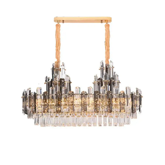 A modern gold decorbites crystal led chandelier with textured cords and cascading clear smoky crystal prisms