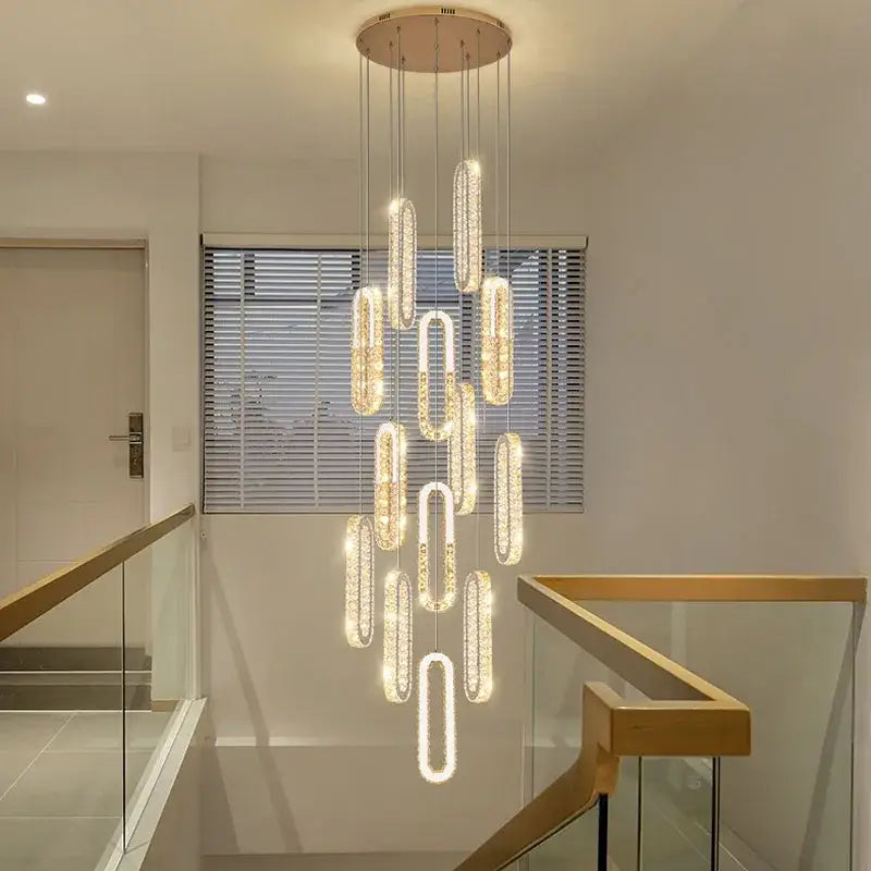 A modern gold decorbites crystal led chandelier with cascading oval crystal pendants for living room staircase