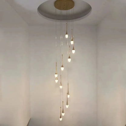A modern gold-toned decorbites crystal led chandelier with teardrop lights suspended from a circular mount