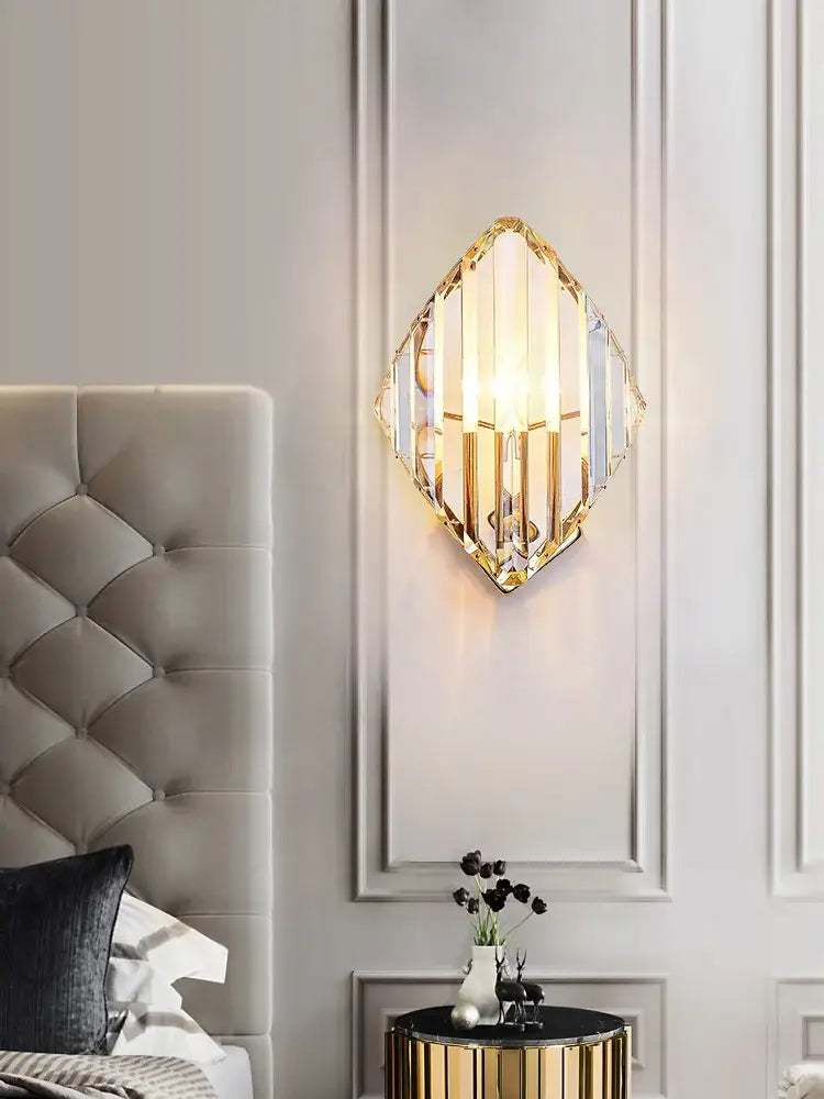 Modern gold decorbites crystal wall sconce with diamond-shaped gold metal frame and clear crystal panels refracting light