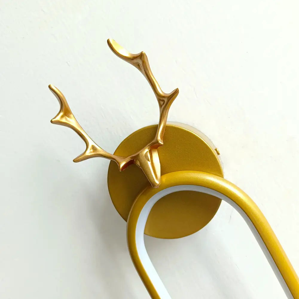 Modern gold deer head wall lamp with arched led sconce features a deer head wall-mounted towel rack with antlers