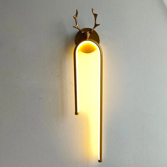 Modern gold deer head wall lamp with arched led sconce emitting warm yellow light for bedroom decorbites deer head decor