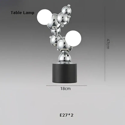 Silver metallic table lamp with black base featuring spherical bulbs in decorbites designer molecule chandelier style