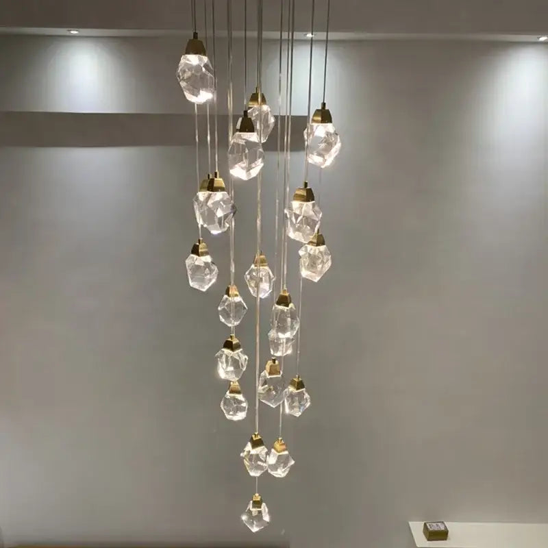 A modern gold diamond crystal ball chandelier with faceted clear glass pendants and metal fixtures for living rooms