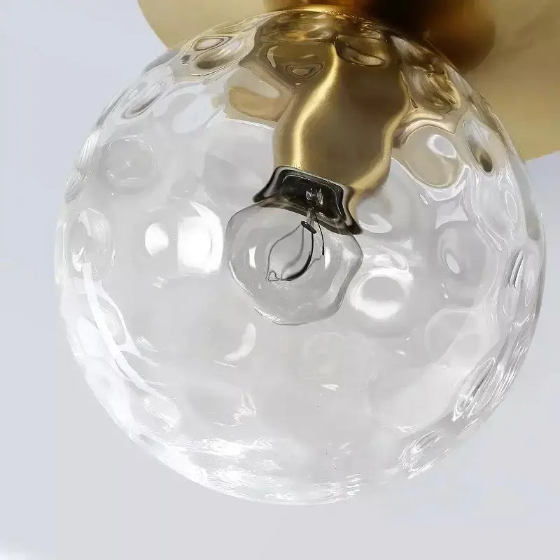 Clear glass globe with hammered texture and gold-toned metal fixture in modern diamond crystal ceiling lights for bedroom