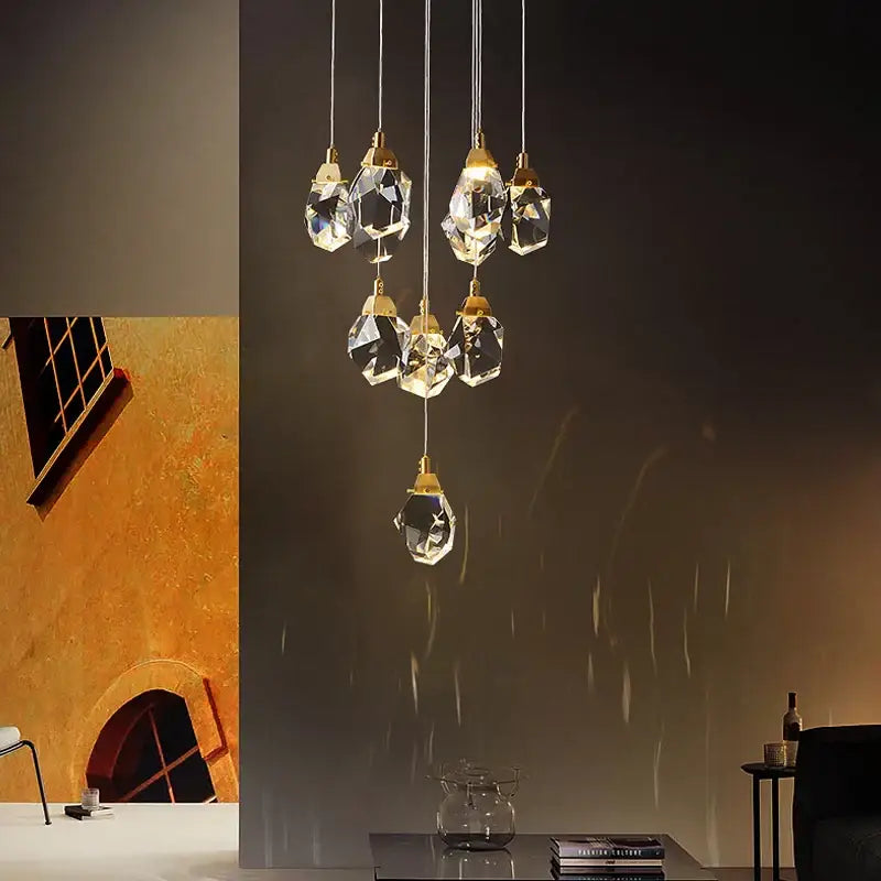 Modern gold diamond crystal chandelier featuring faceted glass pendants and gold-toned metal fixtures for living room lighting