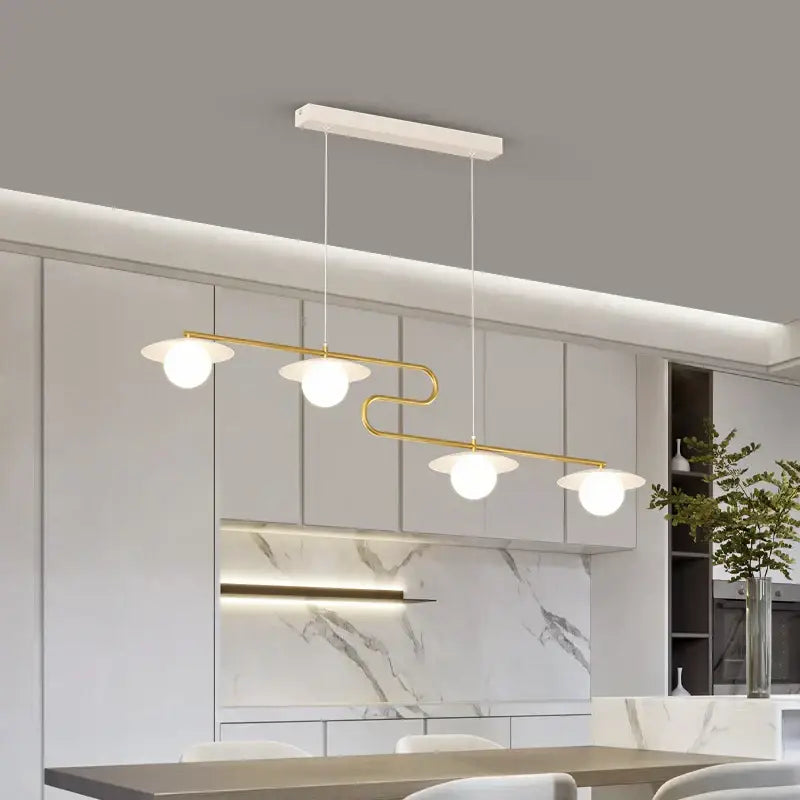 Modern gold dimmable led ceiling chandelier with four frosted glass globes on a white rectangular mount for dining room decorbites dimmable led