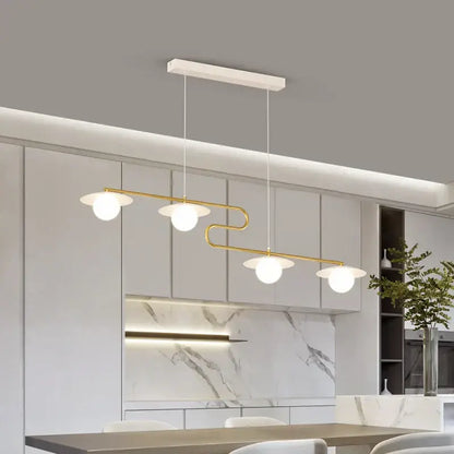 Modern gold dimmable led ceiling chandelier with four frosted glass globes on a white rectangular mount for dining room decorbites dimmable led