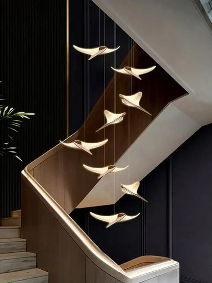 Modern gold dolphin pendant chandelier with seven sleek bird-shaped lights for hotel lobby staircase decorbites dolphin pendant