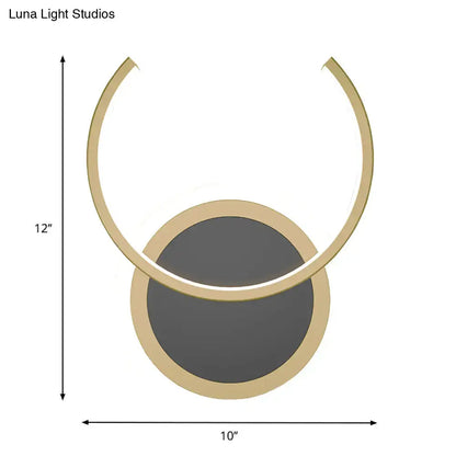 Modern gold dual ring led wall sconce with sleek gold metal frame and two circular glass shades for bedroom lighting