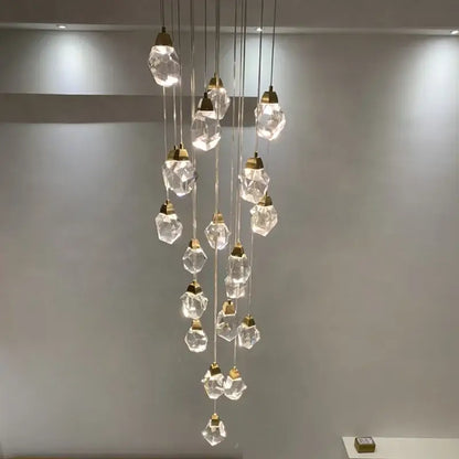 Modern gold elegant crystal chandelier with faceted clear glass pendants and gold-toned metal fixtures by decorbites elegant