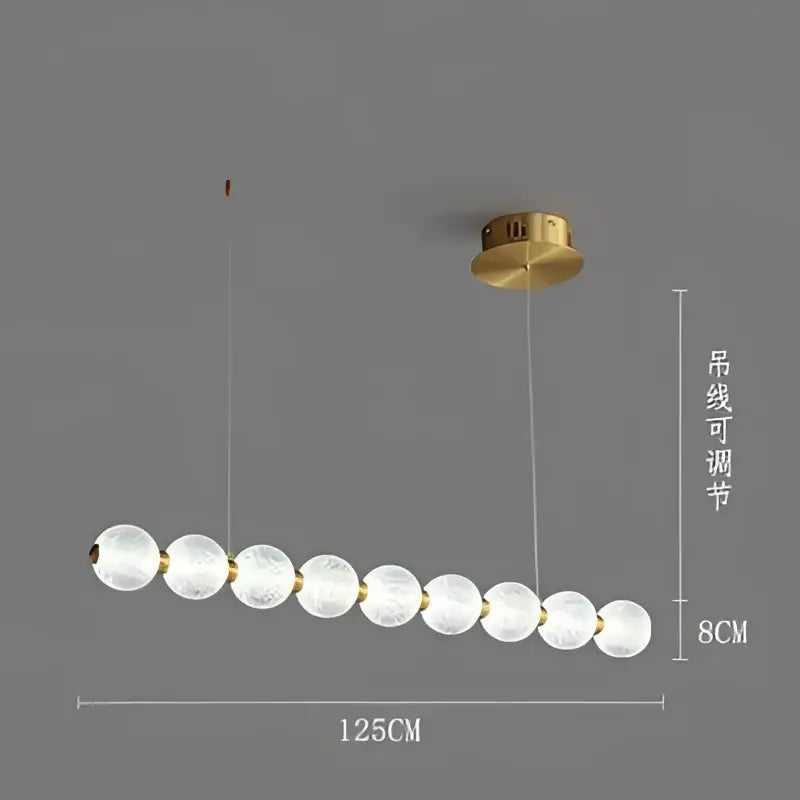 A modern gold elegant pearl necklace chandelier with frosted glass spheres and brass mount for living room decorbites elegant pearl