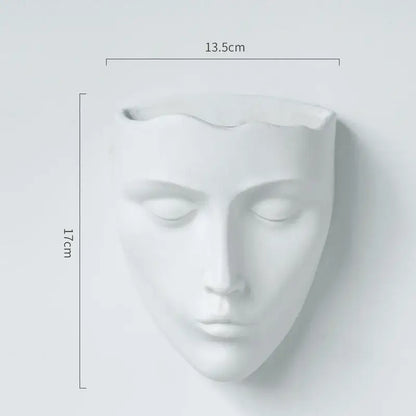 Modern gold face decorbites ceramic wall-mounted vase featuring a minimalist white ceramic closed-eyed face planter