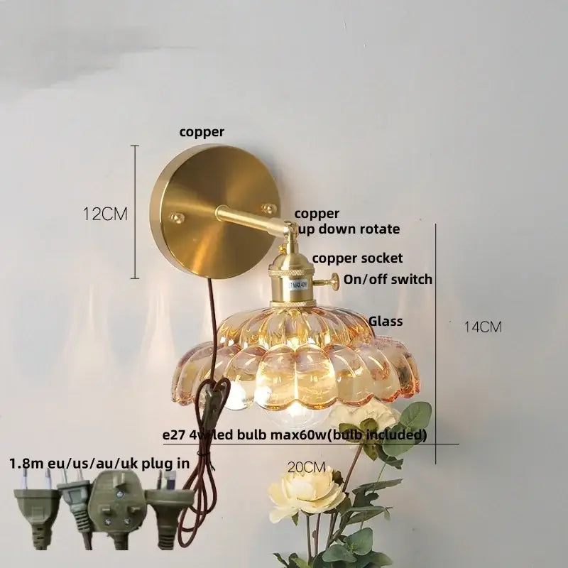 Brass-finished copper wall lamp with adjustable arm and faceted amber clear glass shade for modern wall light use