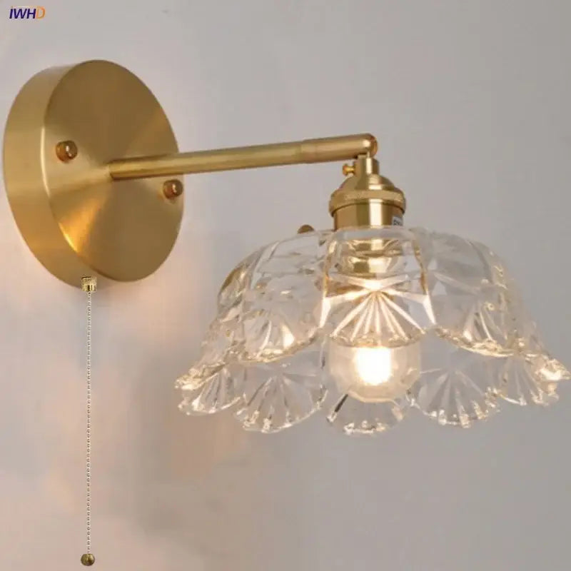 Modern gold faceted clear glass wall light with a gold-toned wall sconce featuring decorbites clear glass shade