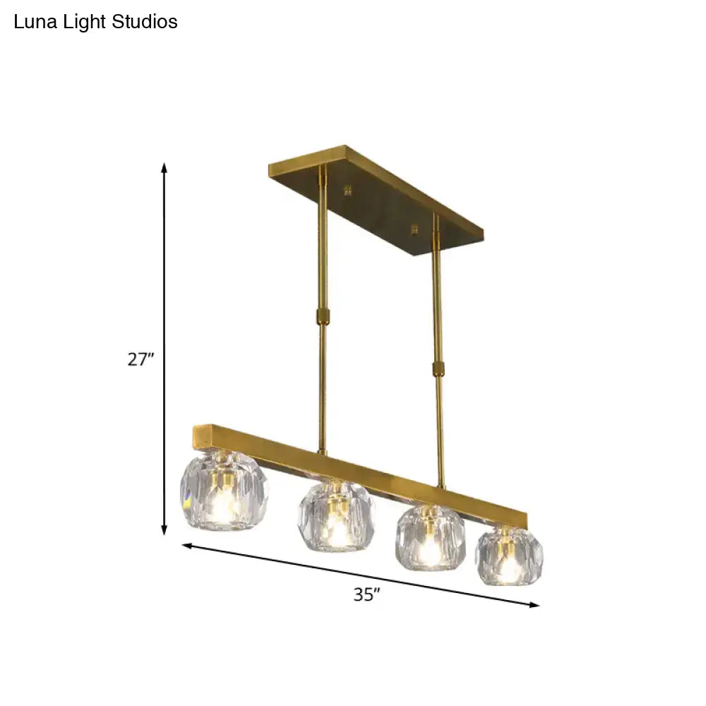 Modern gold island pendant light with rectangular frame and four faceted crystal sphere globe shades for kitchen or dining room