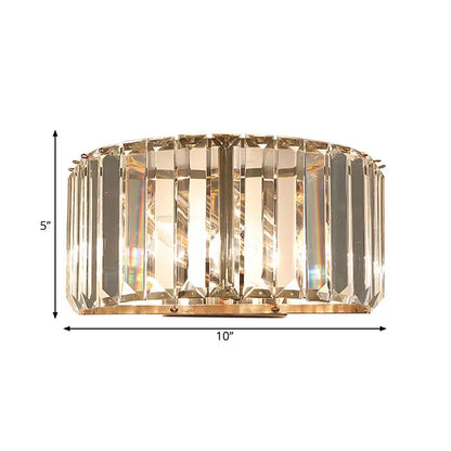 Modern wall sconce with vertical crystal prisms in a gold finish metal frame for bedroom lighting