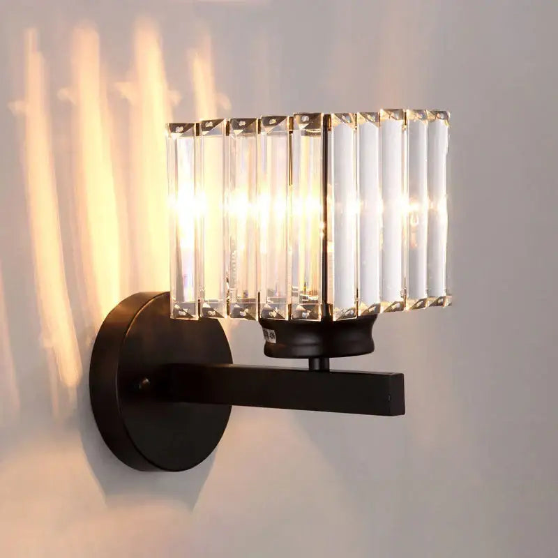 Black metal wall lamp with vertical crystal rods and modern gold faceted glass shade for living room use