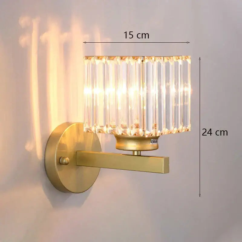 Modern gold wall lamp featuring a faceted glass shade with vertical crystal rods for elegant living room lighting