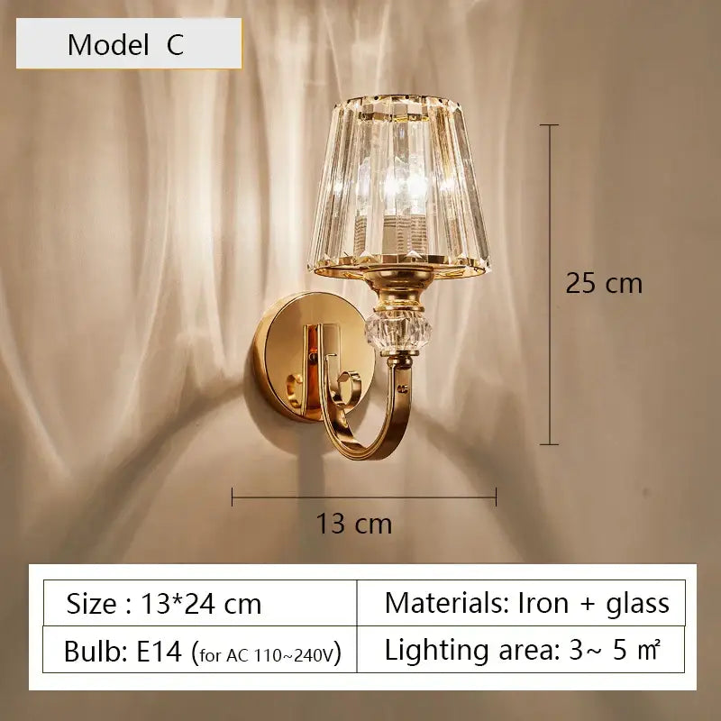 Modern gold wall lamp featuring a faceted crystal glass shade with decorative crystal accents for living room use