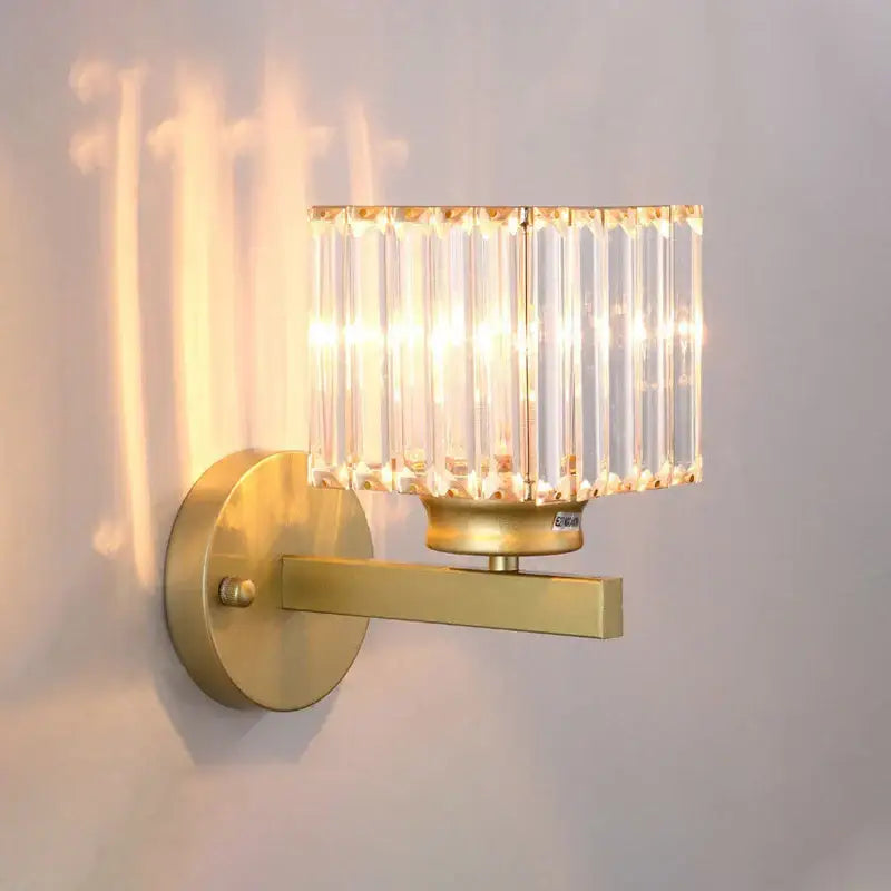 Modern gold wall lamp with a rectangular faceted glass shade composed of vertical glass rods for living room use
