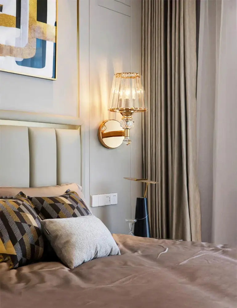 Modern gold wall lamp with crystal-encrusted tiered faceted glass shade for elegant living room wall lighting