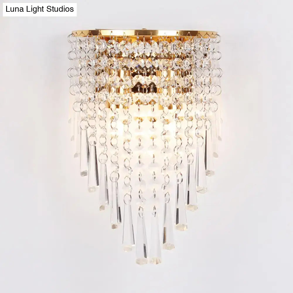 Modern gold finish wall light with clear crystal droplets and prisms designed for bedroom sconce lighting