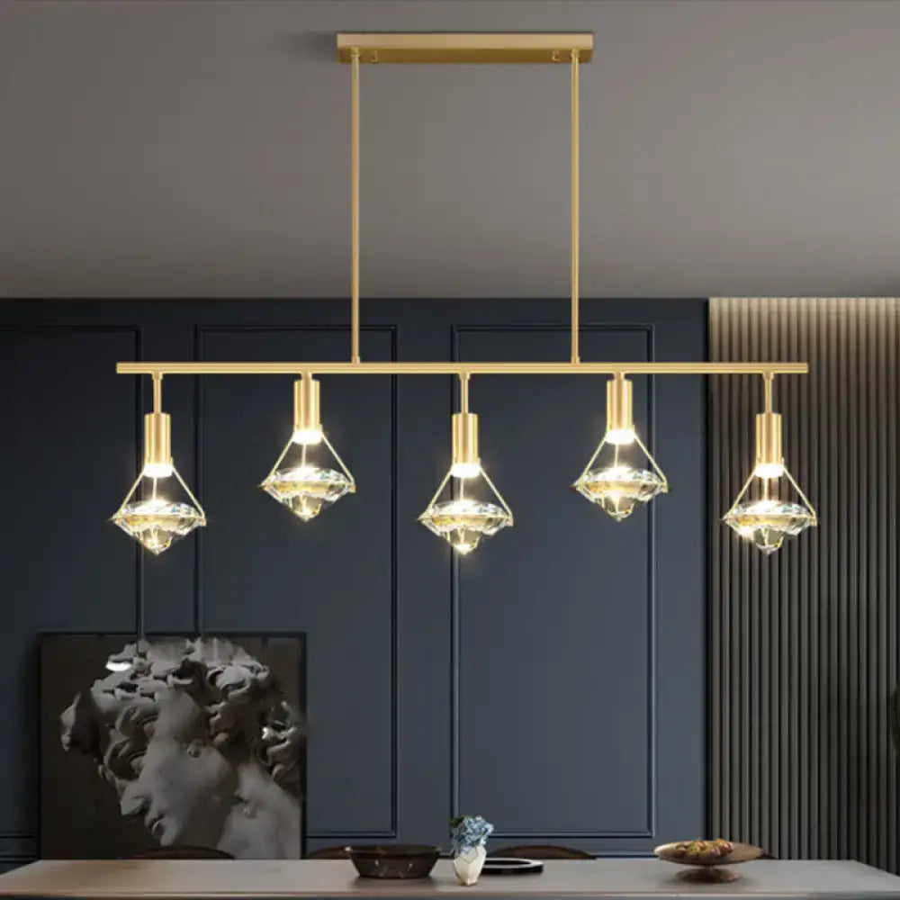 Modern gold finish crystal pendant light fixture with five gold-toned crystal-encrusted lights for kitchen island