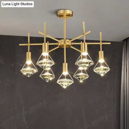 Modern gold finish light fixture with five crystal diamond-shaped shades on geometric frame for kitchen island