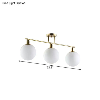 Decorbites modern linear chandelier with three milk glass orb shades and gold finish polished brass frame